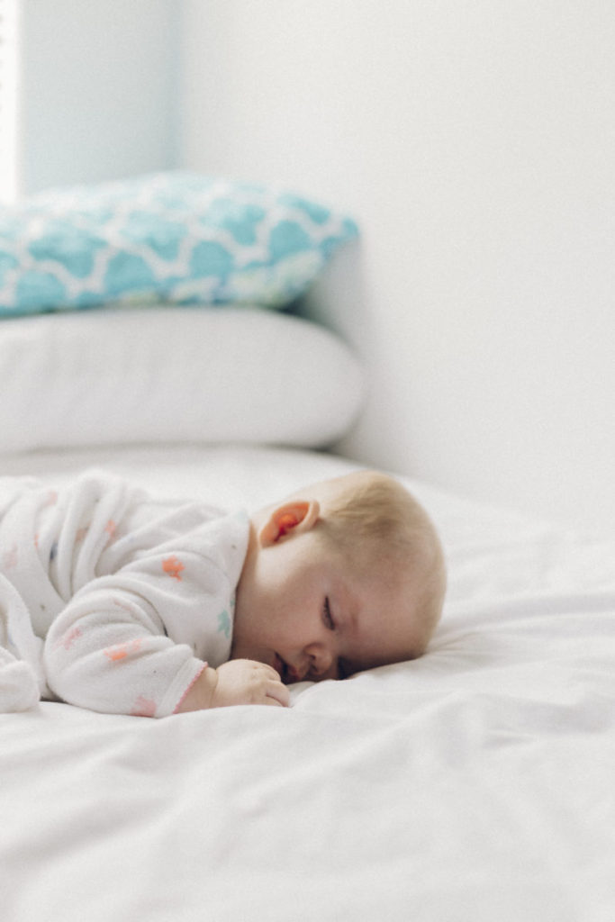 newborn/baby taking a nap on stomach 