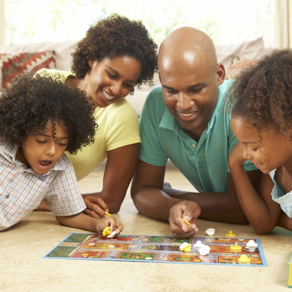 African American family playing board game family fun