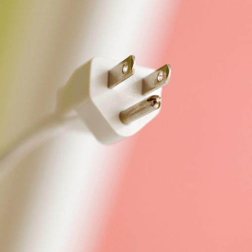 white plug green and pink background