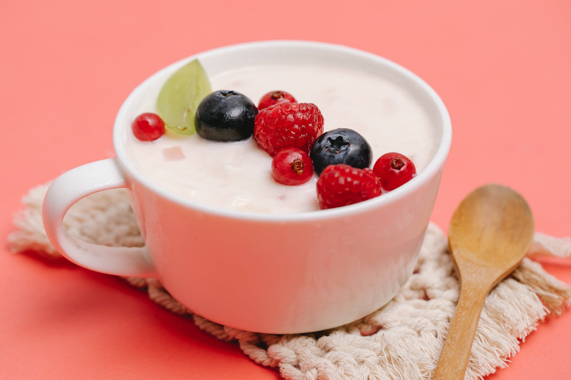 delicious yogurt dessert with berries on coaster