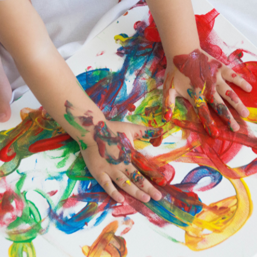 toddler painting with hands